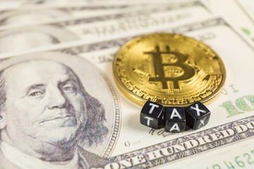 Bitcoin tax concept on dollar bills