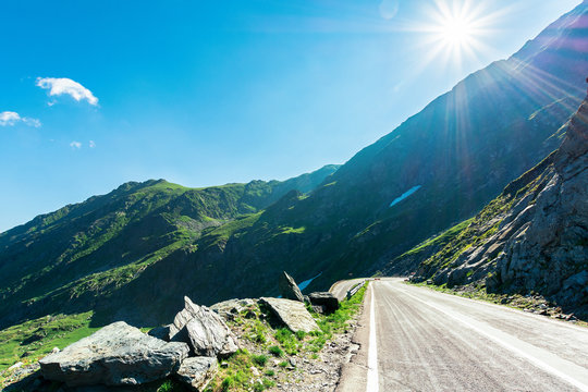 transfagarasan road though mountains. wonderful sunny forenoon weather. rocky slopes and grassy hills. beautiful travel destination. discover romania concept