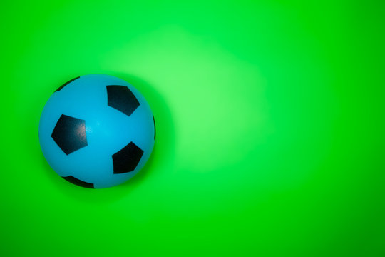 Soccer ball. Blue football on green background.