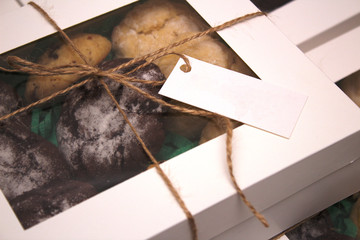 packed and rope tied cookie boxes with transparent cover and and a label for text