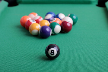 Billiard balls on a green table close-up