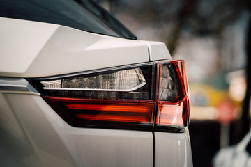 Close up photo of back view luxury car with futuristic tail lights