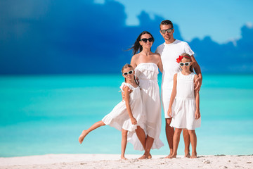 Happy beautiful family with kids on the beach