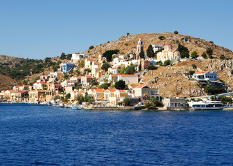 Colorful architecture of the buildings of the rocky shore of the island Symi.