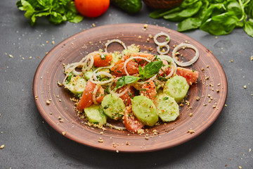 Fresh spring detox mix salad with vegetables such as tomatoes, cucumbers and onion