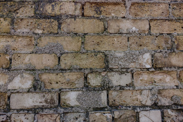 old brick wall and missing bricks in ruins.