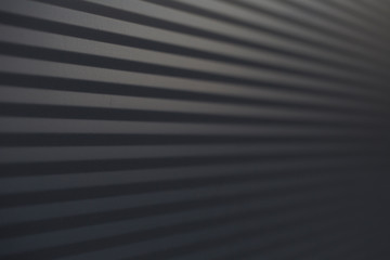 Black clear background with corrugated iron in horizontal orientation.