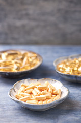 Coenzyme Q10, Omega 3 and Vitamin E capsules. Dietary supplements. Rustic wooden background. Top view. Copy space. 