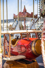 A plane and a white wooden horse on a merry-go-round