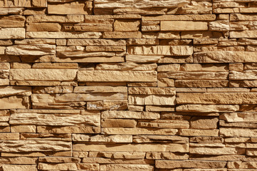 Rock stone brick tile wall has a detailed background texture sepia cream brown color stacked in layers, you can use this image as a background image with a texture image