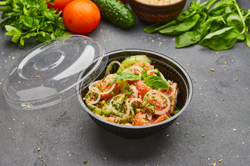 Fresh spring detox mix salad with vegetables such as tomatoes, cucumbers and onion