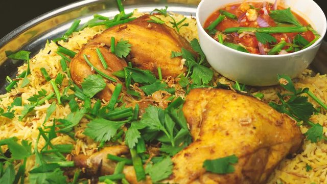 spreading parsley on the chicken arab kabsah rice