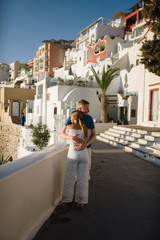 Fototapeta na wymiar young couple honeymoon on the most romantic island Santorini, Greece, view of Santorini