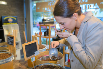 female barista checking coffee beans