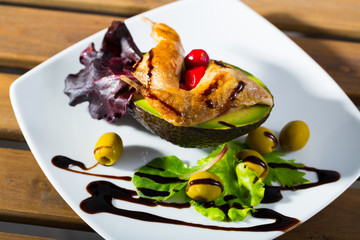 Delicious fried legs of quail with balsamic pasta, avocado and greens