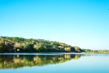 Amazing landscape of lake with clear green water and Perfect blue sky. Ukraine