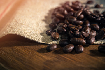 Coffee beans, close-up on rough sackcloth 