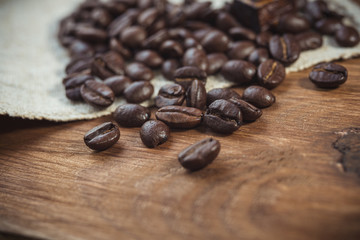 Coffee beans, close-up on rough sackcloth 