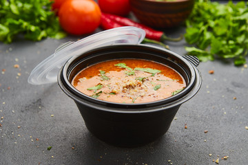 Traditional Georgian soup Kharcho with meat and rice on dark stone background