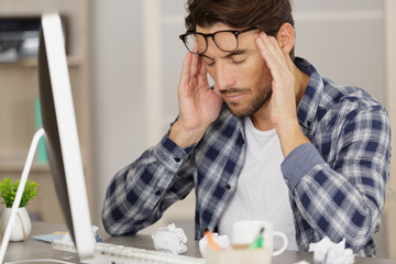 businessman with headache in office