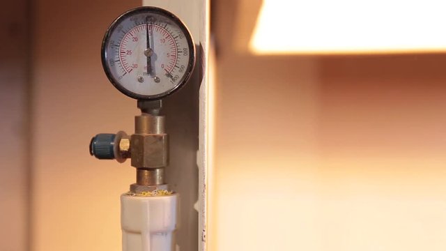 Pressure reading on the manometer is close-up. Measuring instruments in the factory. The arrow on the device rolls over.
