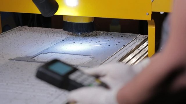 Industrial remote CNC control panel of machinery at cutting factory.