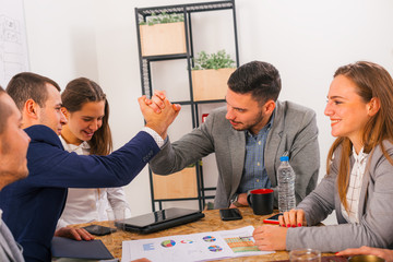 Handshake and smile at the business meeting table between business partners.