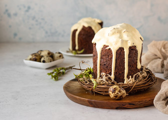 Traditional Orthodox Easter sweet bread or cake with chocolate. Chocolate Kulich  decorated with orange glaze.