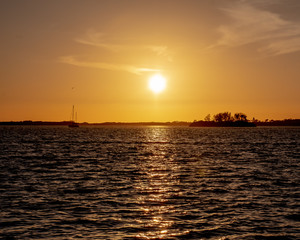Naklejka na ściany i meble Sunset and boat on the inter coastal waterways of Florida, USA