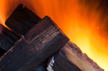 Burning fire, oak firewood in a home compact oven with good traction for heating a house...