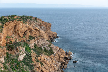 Fototapeta na wymiar Shore cliffs sea ocean rocky orange clear sky