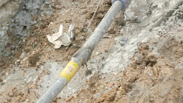 Dirty oily fluid seeps from the hole in the hose