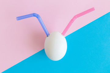 Egg with multicolored drinking straws cocktail abstract.