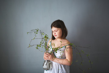 spring,girl with vase with blossoming buds ecology