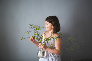 spring,girl with vase with blossoming buds ecology