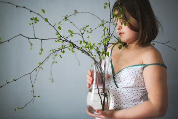 spring,girl with vase with blossoming buds ecology