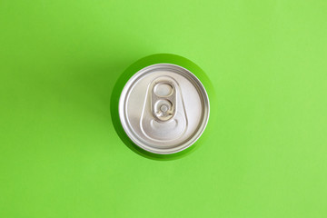 Top view of drink can isolated on green.