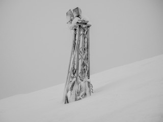 Frozen light mast  on the snow slope of mountain in Khibiny at the coldest winter time