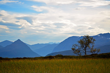 Mountain landscape from top of fjords in Volda, Norway. Snow covered peaks