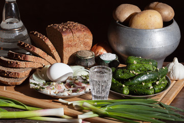 Bread potato onion cucumber on wooden background