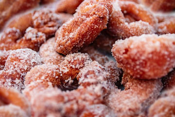 Multiple homemade doughnuts coated with sugar