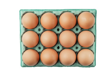 Twelve chicken eggs in paper packaging close-up.