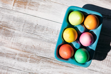 Fototapeta na wymiar Bright And Colorful Easter Eggs On Weathered Wood