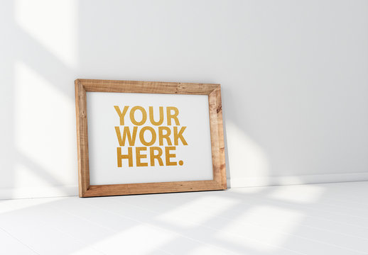 Horizontal Wooden Frame Leaning on a White Wall Mockup