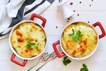 Potato casserole with bechemel sauce and cheese on the kitchen table. Top view.