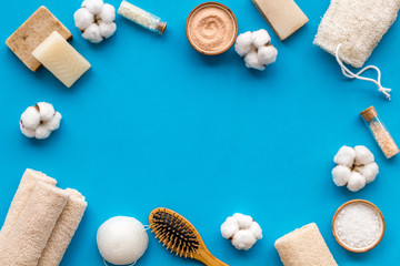 Spa set with eco materials for organic treatment on blue background top view space for text