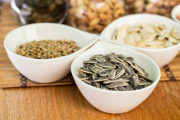 Various piles of mixed nuts and seeds