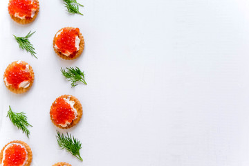 Frame for text with sandwiches with red caviar of salmon on the side. Infoblock. Sea banner. Luxury and wealth. Healthy food, protein food.