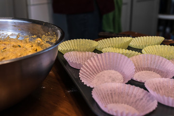empty paper muffin liners placed in a muffin tray
