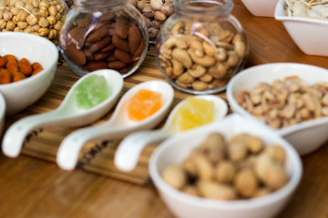 Various piles of mixed gummy candy and nuts 